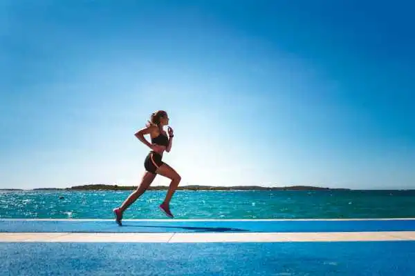 Woman running showing strong leg muscle Bedfordshire